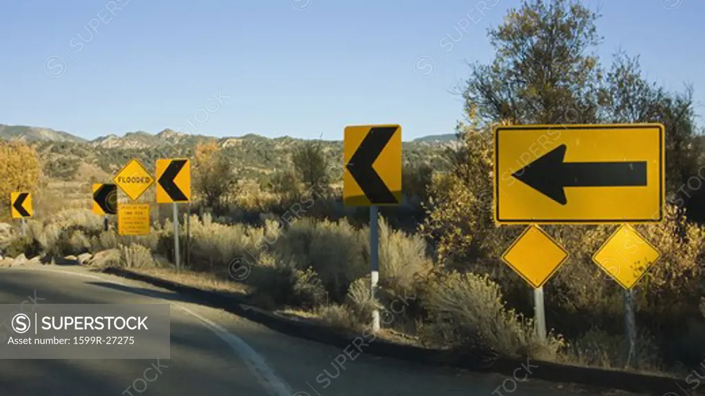 Yellow road signs pointing to go left on highway 33, California on way to Ojai