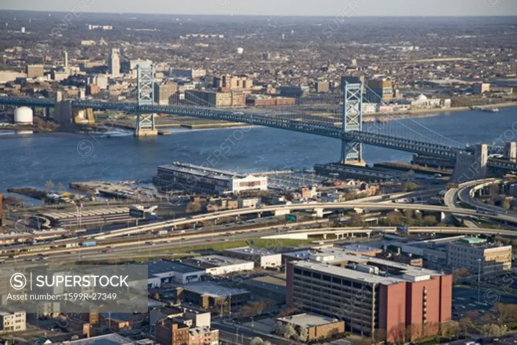 Aerial view of Ben Franklin bridge crossing the Delaware River from Philadelphia, Pennsylvania side into Camden New Jersey
