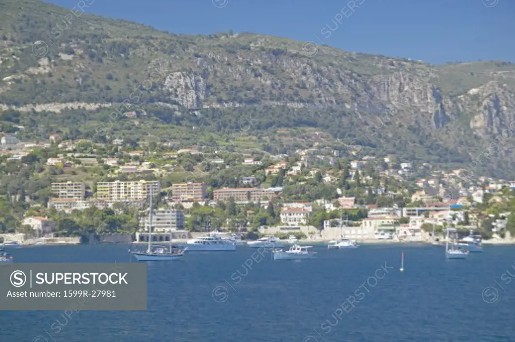 Boats docked near hillside on French Riviera, France