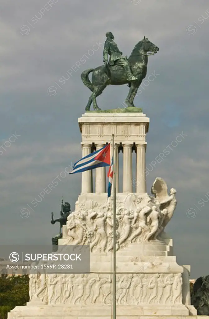Monument to Maximo Gomez with Cuban flag blowing in the wind in Old Havana, Cuba