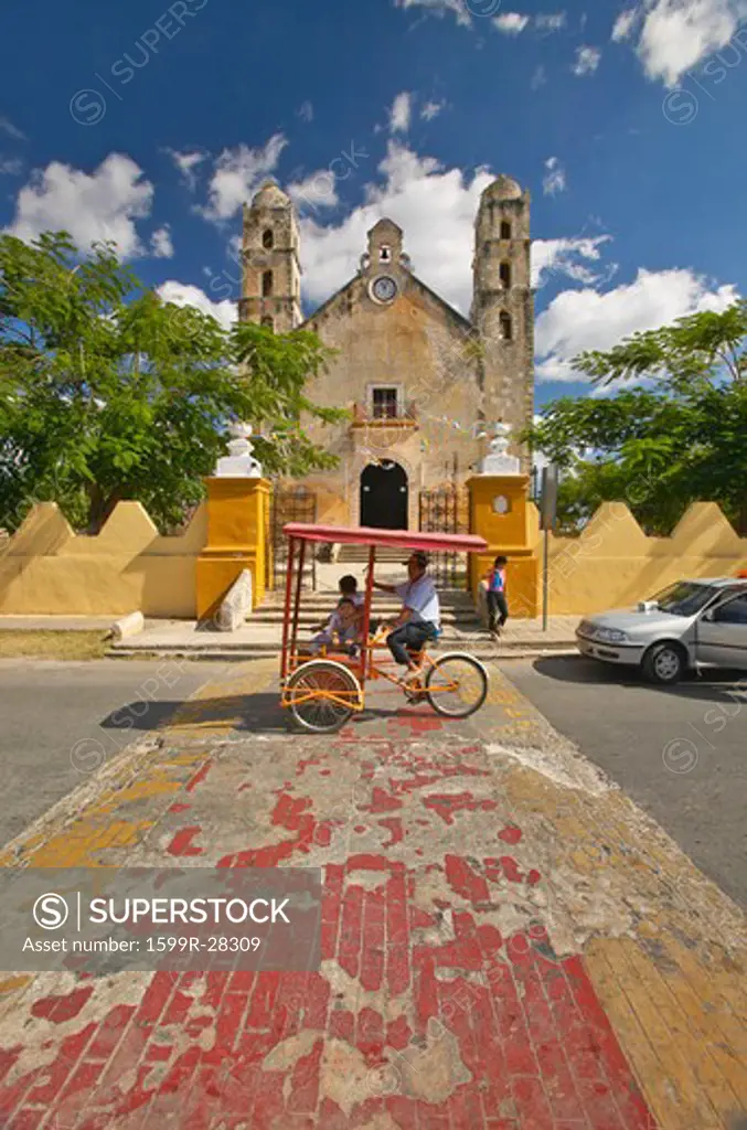 Bicycle taxi in front of Catholic cathedral of Izamal, Yucatan Peninsula, Mexico
