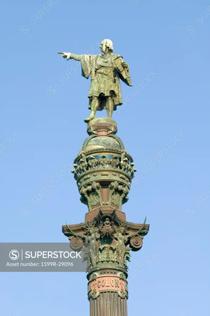Statue of Christopher Columbus points west to New World, next to waterfront of Port Vell, Barcelona, Spain