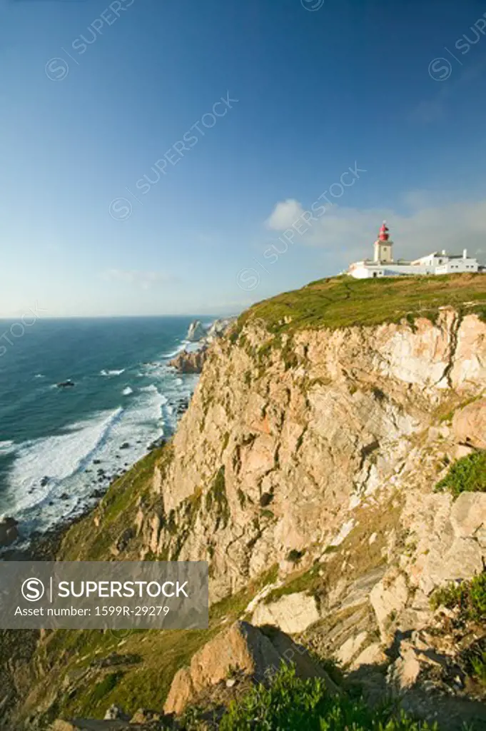 Cliffs and lighthouse of Cabo da Roca on the Atlantic Ocean in Sintra, Portugal, the westernmost point on the continent of Europe, which the poet Camões defined as ''where the land ends and the sea begins''.