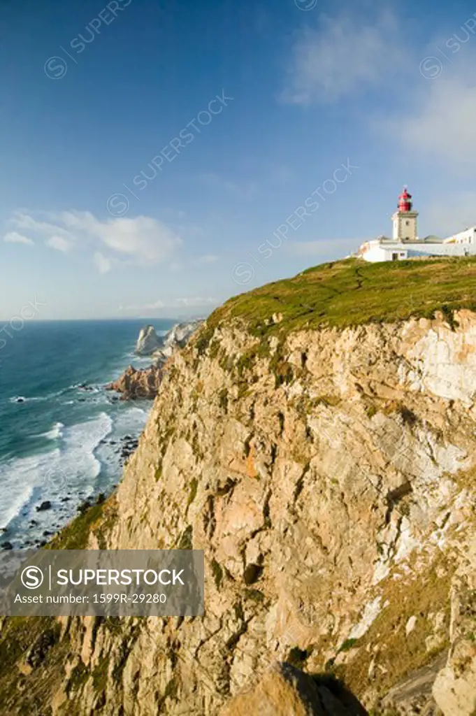 Cliffs and lighthouse of Cabo da Roca on the Atlantic Ocean in Sintra, Portugal, the westernmost point on the continent of Europe, which the poet Camões defined as ''where the land ends and the sea begins''.