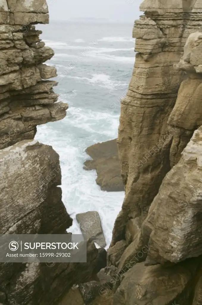 Atlantic ocean sprays water on rocks at Cruz do Remedios, near Peniche, west coast of Portugal