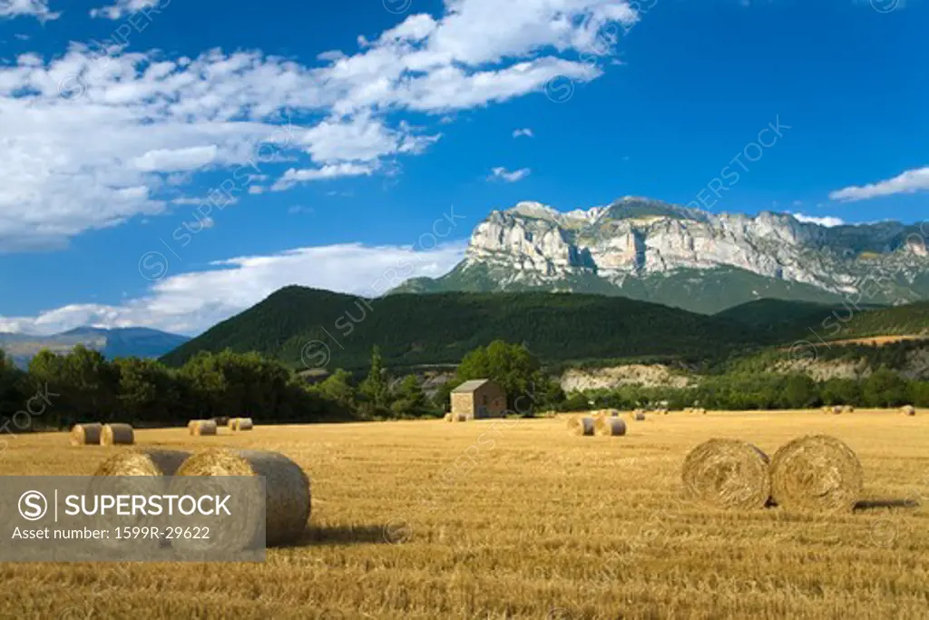 Hay bails with sweeping views of Parque National de Ordesa near Ainsa, Huesca, Spain in Pyrenees Mountains