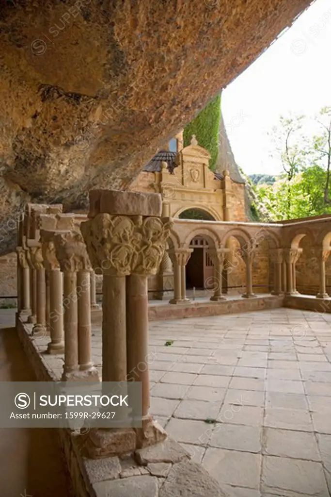 The Monastery of San Juan de la Pena, Jaca, in Jaca, Huesca, Spain, carved from stone under a great cliff.  It was originally built in 920 AD and in 11th Century, became part of Benedictine Order, the site thought to house the legendary Last Supper ''Holy Grail'' and associated with the legend of ''Monte Pano