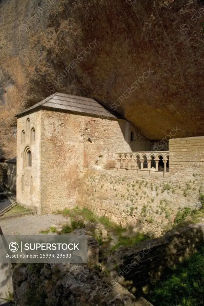 The Monastery of San Juan de la Pena, Jaca, in Jaca, Huesca, Spain, carved from stone under a great cliff.  It was originally built in 920 AD and in 11th Century, became part of Benedictine Order, the site thought to house the legendary Last Supper ''Holy Grail'' and associated with the legend of ''Monte Pano