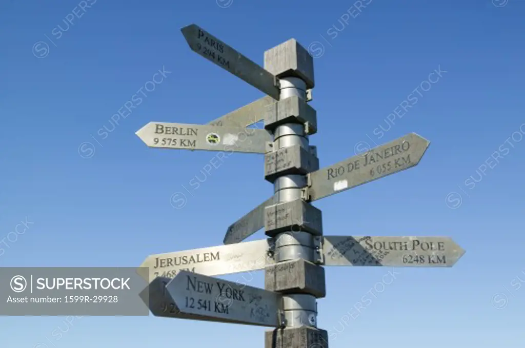 Signs point with mileage totals to Berlin, Jerusalem, New York, South Pole, Paris, Rio De Janeiro at Cape Point, Cape of Good Hope, outside Cape Town, South Africa