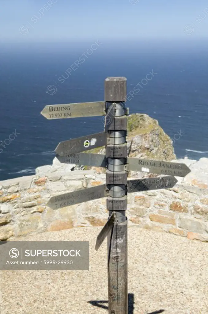 Signs point with mileage totals to Beijing, Jerusalem, New York, South Pole, Paris, Rio De Janeiro at Cape Point, Cape of Good Hope, outside Cape Town, South Africa