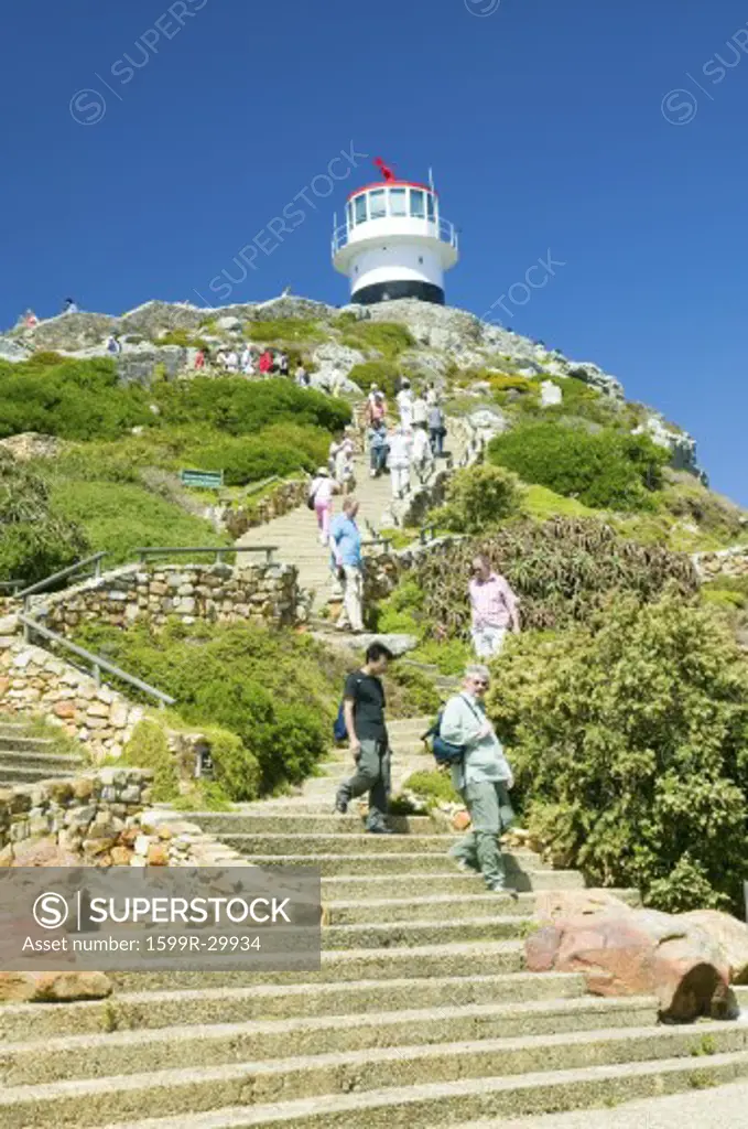 Tourists walking up steps leading to old Cape Point Lighthouse at Cape Point outside of Cape Town, South Africa