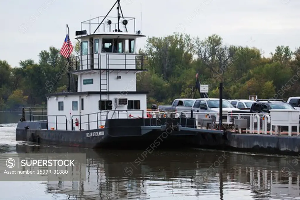 Belle of Calhoun ferry boat shuttlesat Brussels, Il. Is a free ferry carrying cars across the Mississippi and Illinois River to Missouri