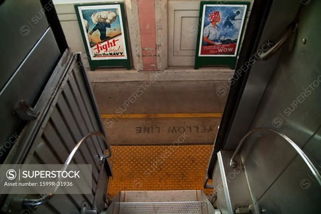 Historic posters can be seen from stairs of Pearl Harbor Day Troop train reenactment from Los Angeles Union Station to San Diego