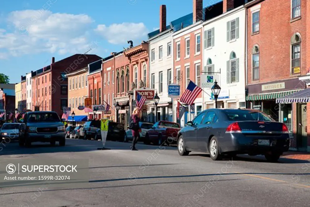 Female in purple sweater crosses Water Street in Hallowell, Maine