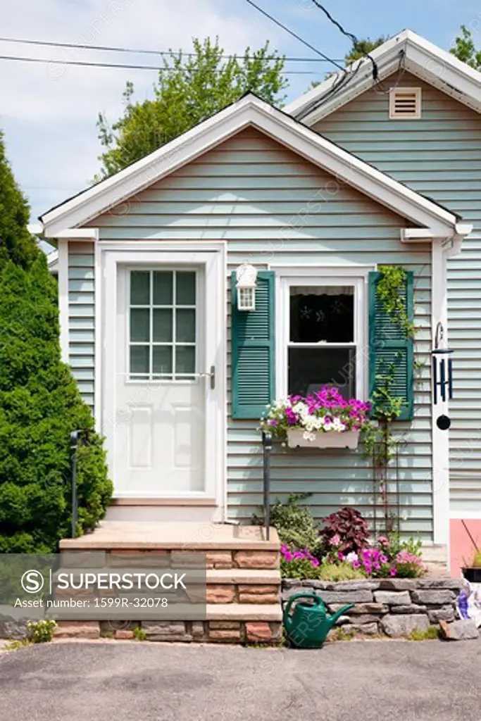 Cute home with flowers on front porch, summer, Maine