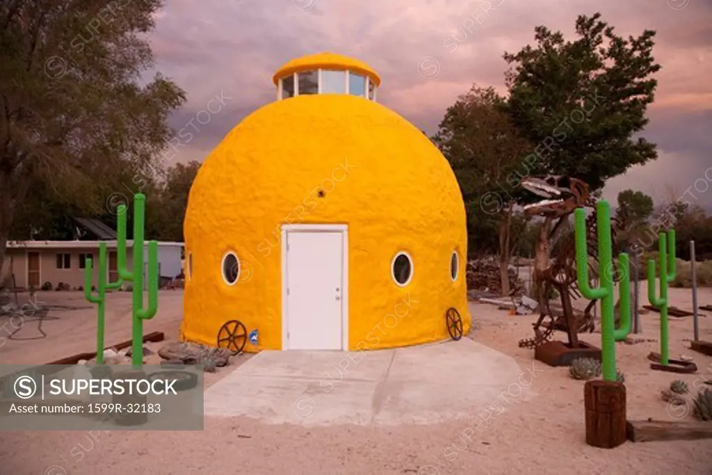 Roadside attraction shows campy objects in front of Yellow domed house, along Route 395, California