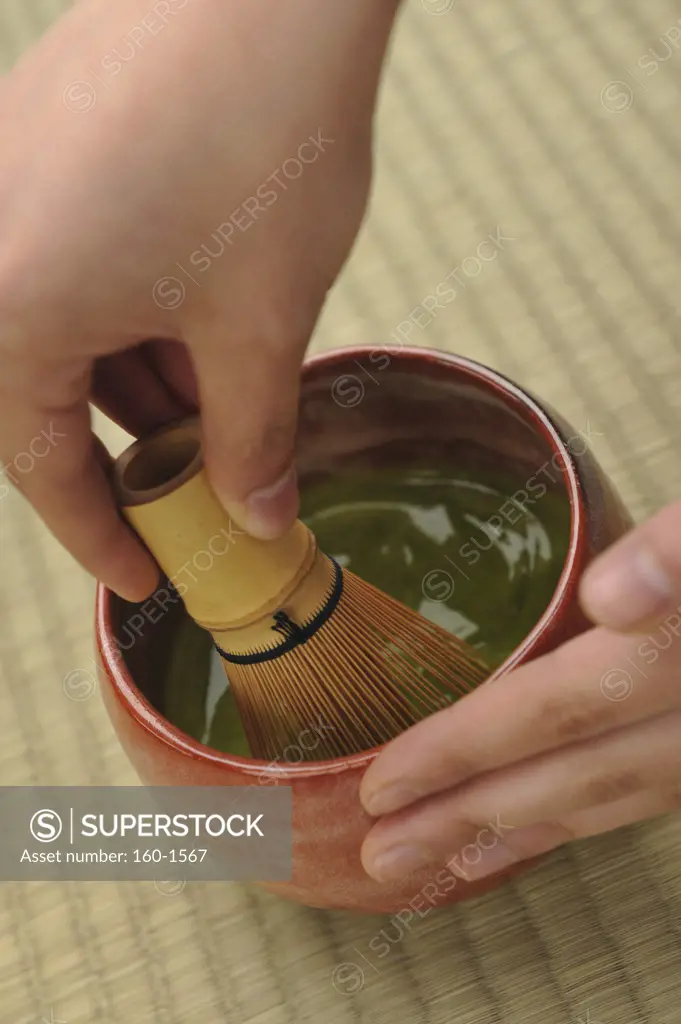 Person preparing tea for tea ceremony