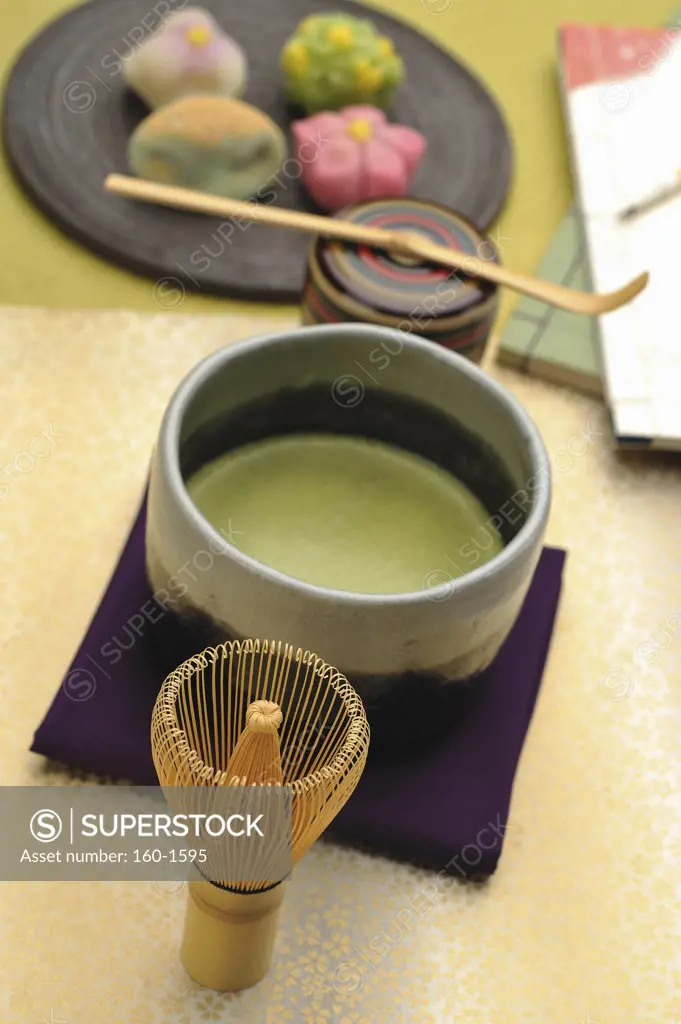 Japanese tea cup with a tea whisk and Nerikiri the traditional Japanese sweet on a tray