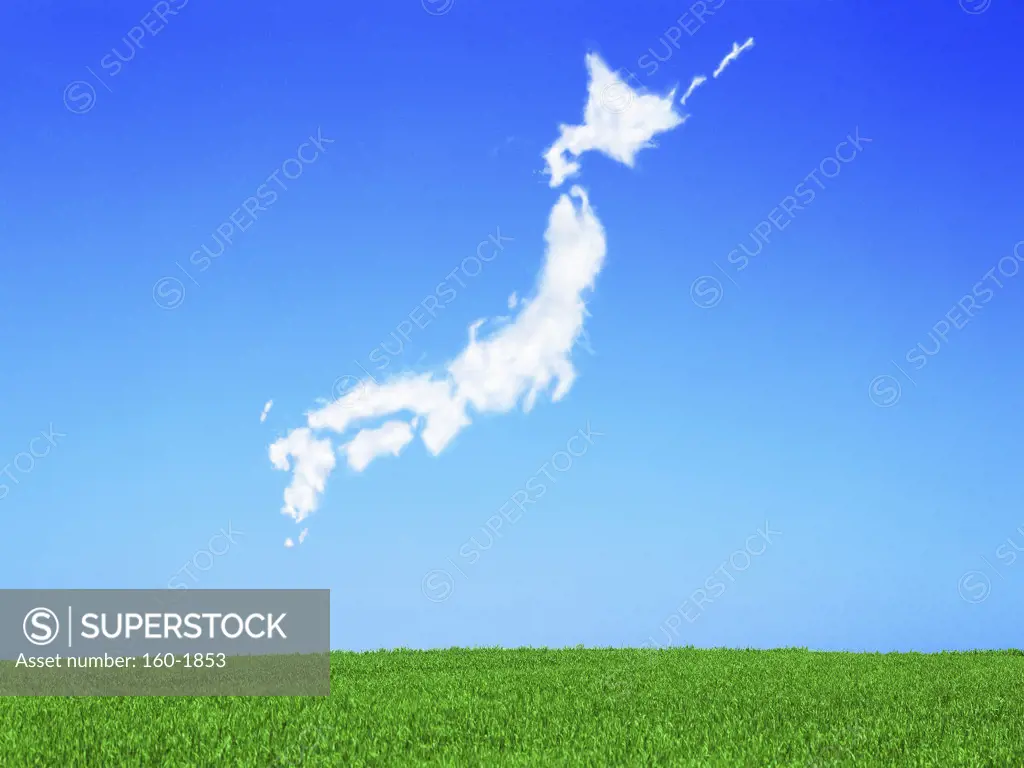 Japan-shaped cloud over green meadow, digitally generated image