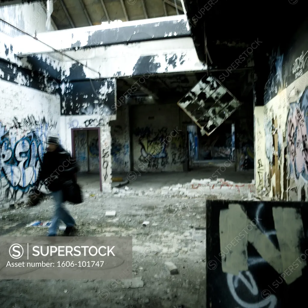 Passer-by in disused plant