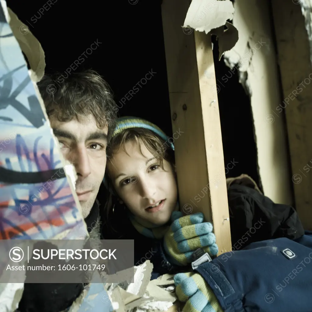 Portrait man and teenage girl in disused plant