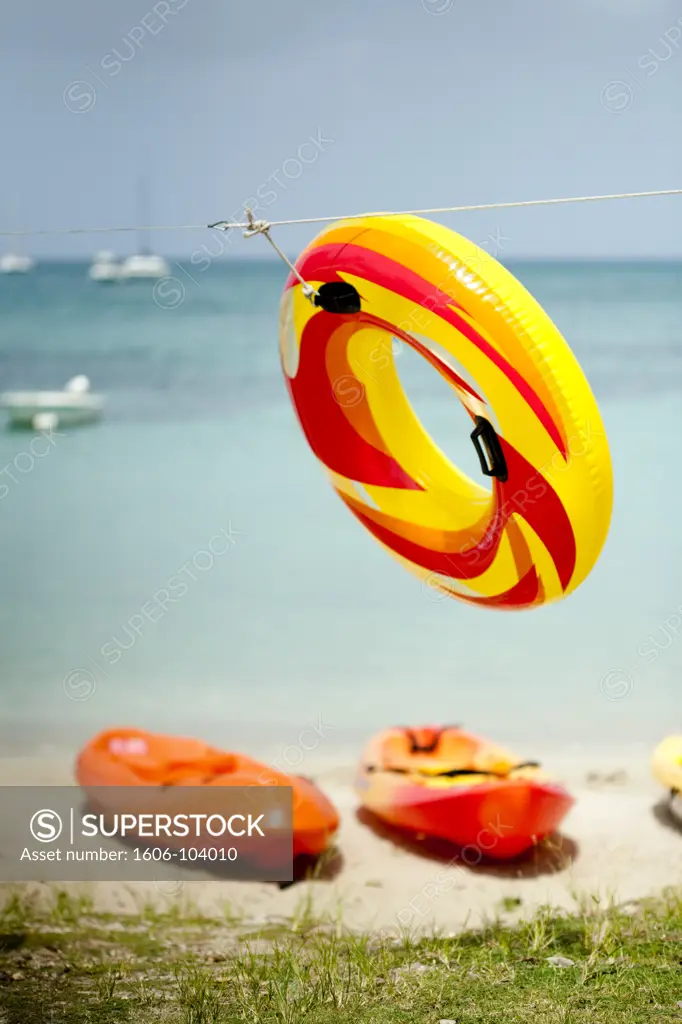 French West Indies, Martinique, kayaks on the beach, inflatable ring