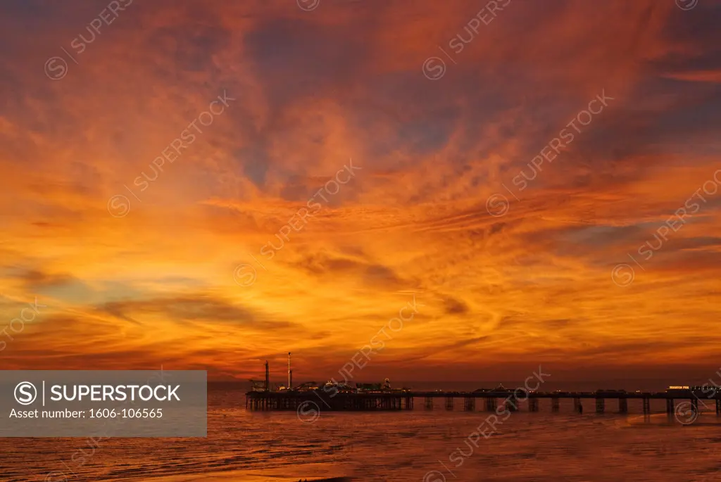 England, Sussex, Brighton, Brighton Pier in the Evening with a red sky