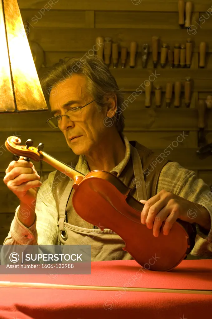 Man tuning a violin