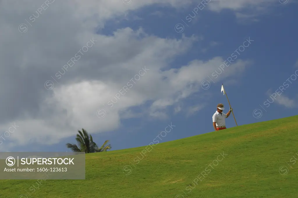 Mauritius, golfer taking a flag on the green
