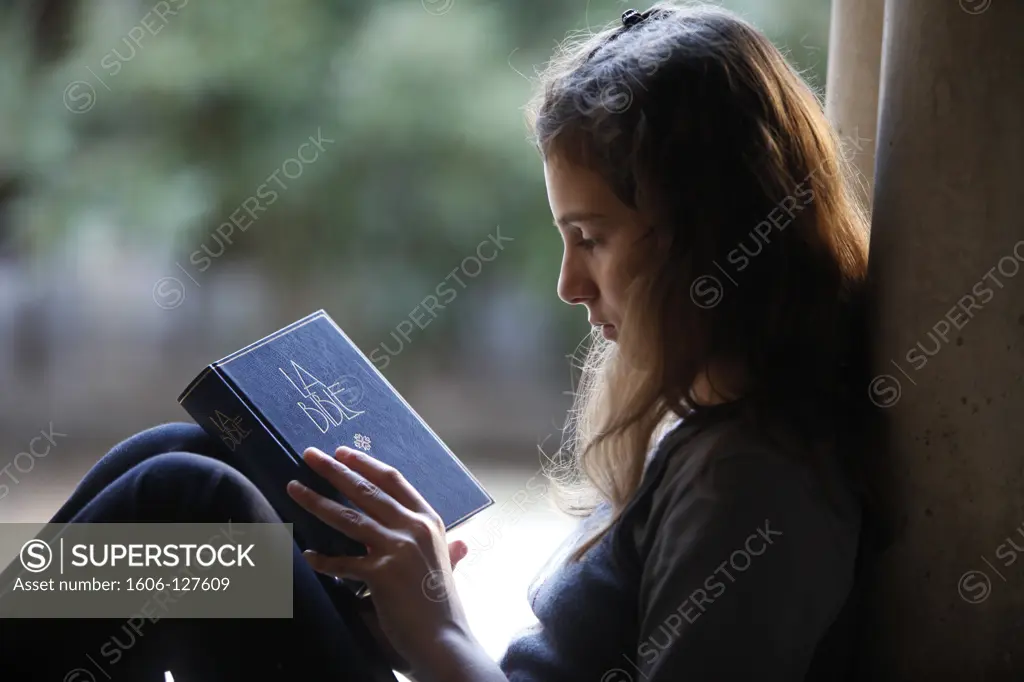 France, Bouches-du-Rhne, Montmajour, Girl opening a Bible    France