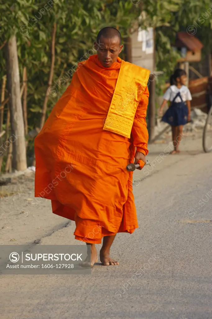 Cambodia, Siem Reap, Siem Reap, Buddhist monks making alms run in early morning.   Cambodia.