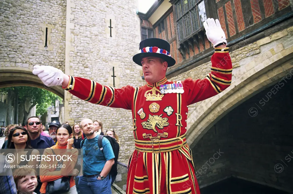 England,London,Tower of London,Beefeater in State Dress giving Guided Tour to Tourists