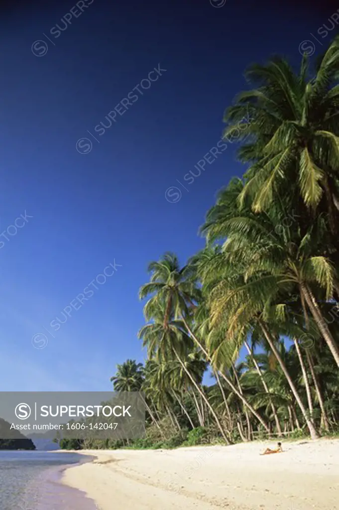 Philippines,Palawan,Bascuit Bay,El Nido,Girl Sunbathing on Tropical Beach