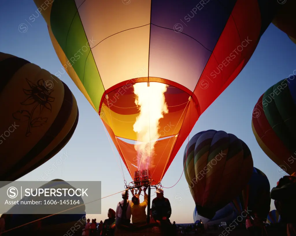 USA, New Mexico, Albuquerque, Colourful Hot Air Balloon being Inflated / Dusk