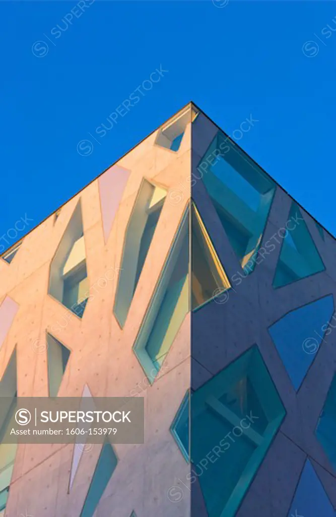 The afternoon sun illuminates the concrete and glass exterior of the Tod's Building (Italian Luxury Leather), designed by Japanese architect, Toyo Ito, on Omotesando Avenue in the trendy yet upscale Harajuku District of Tokyo, Japan.