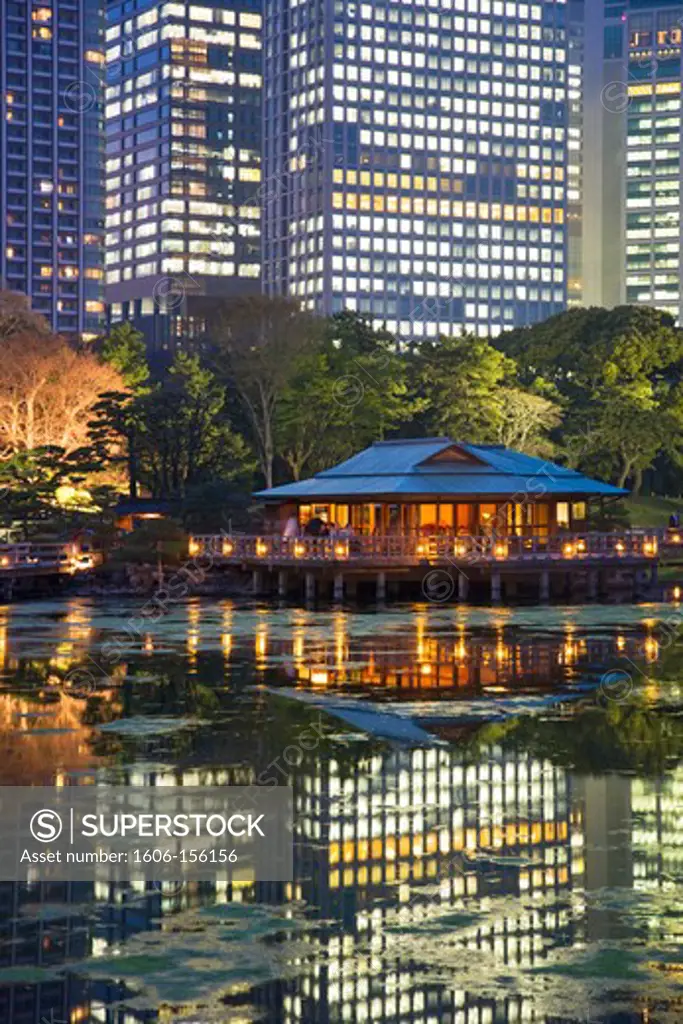 The Shiodome business complex forms a solid wall behind Hama-Rikyu Gardens with its refined Nakajima Teahouse at twilight, and functions as a contemporary Borrowed Landscape (a tradition in Japanese garden design incorporating distant scenery), with spark