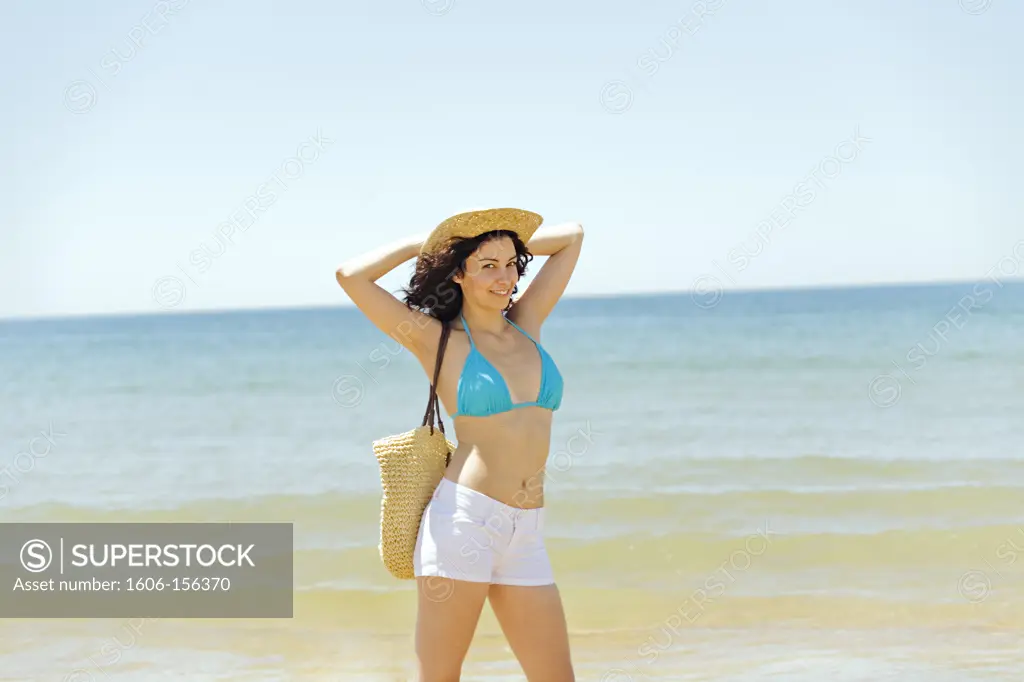 Portrait of a young brunette woman at the beach