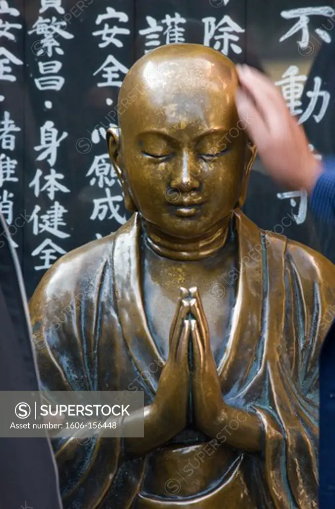 A detailed view reveals the beautiful bronze sculpturing of a Nadebotoke (Rubbing Buddha) Jizo statue, which worshippers may rub for good health, at Sensoji Temple (also known as Asakusa Kannon Temple) in Asakusa, located in the old shitamachi downt ...