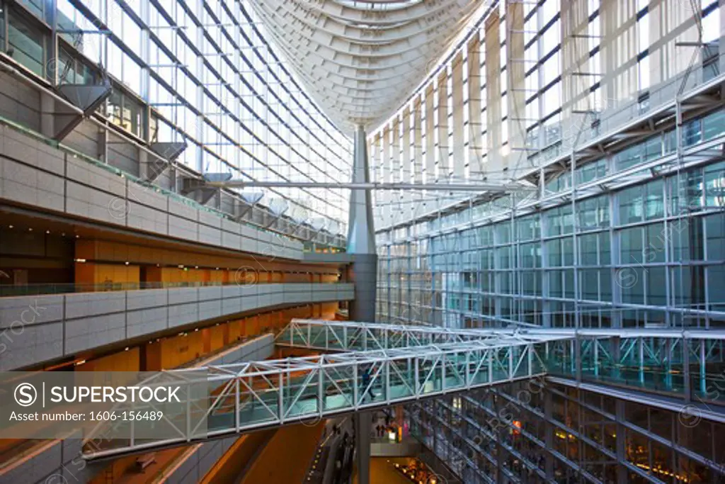 A wide-angle interior view captures the spacious 60-meter high atrium's laminated-glass and steel structure in the hull-shaped Glass Building, the main entrance hall for the Tokyo International Forum (Japan's largest conference, art, and congress ce ...
