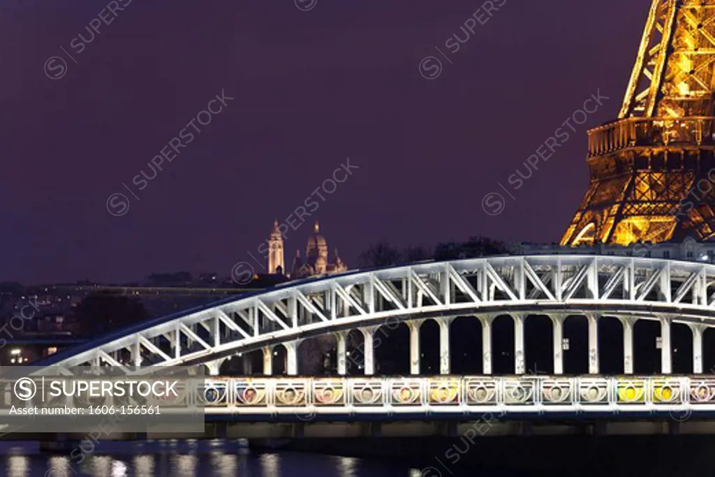 France, Paris, The Eiffel tower and RER bridge over the Seine river at night