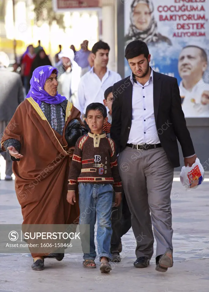 Turkey, Sanliurfa, family walking in the street,