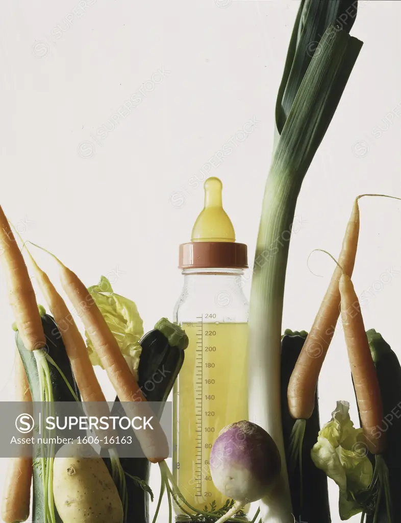 Vegetable stock in a feeding bottle, carrots, potatoes, leek, turnip...