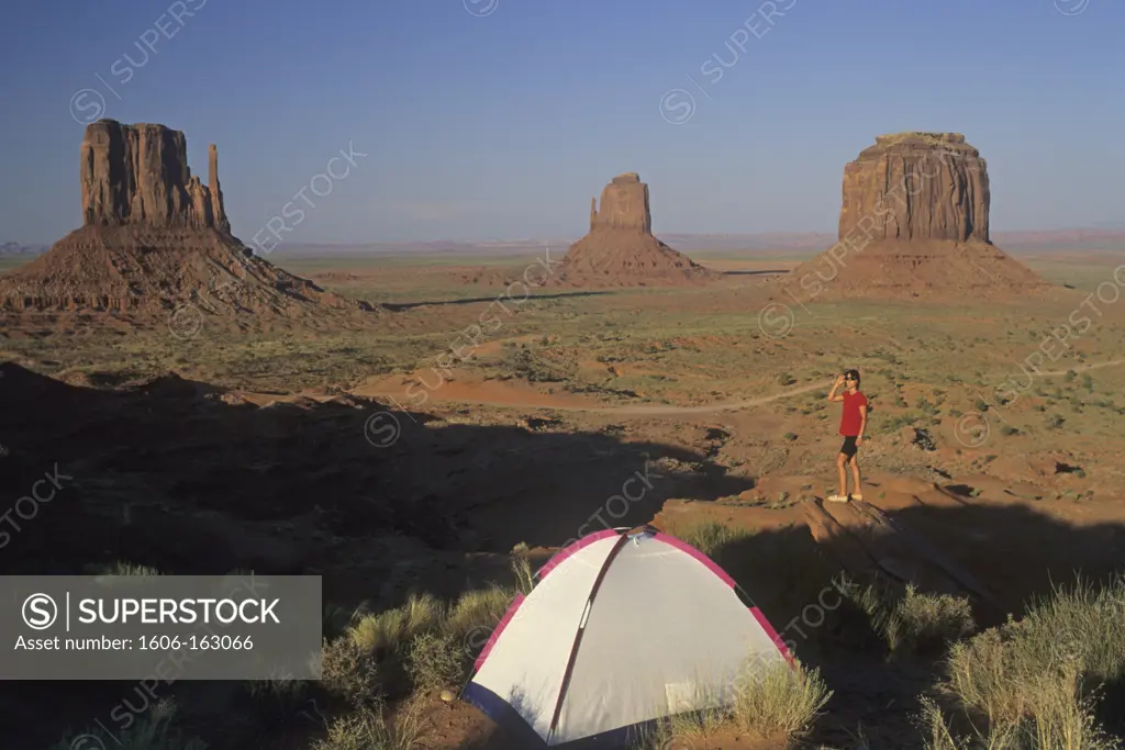 Arizona,monument valley, les Mittens, woman on a rock , tent, dusk