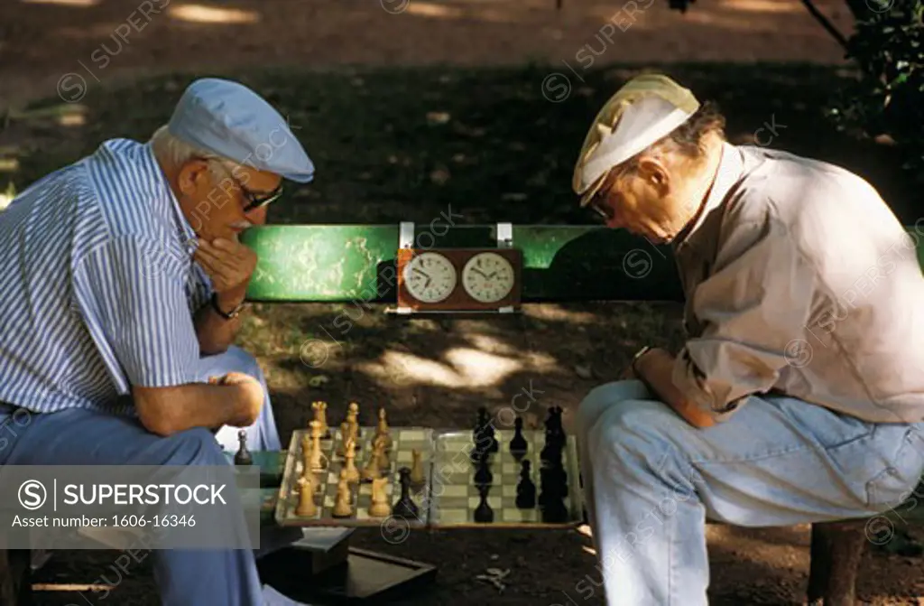 Argentina, Buenos Aires, 2 men  sitting on a bench, facing each other, playing chess,