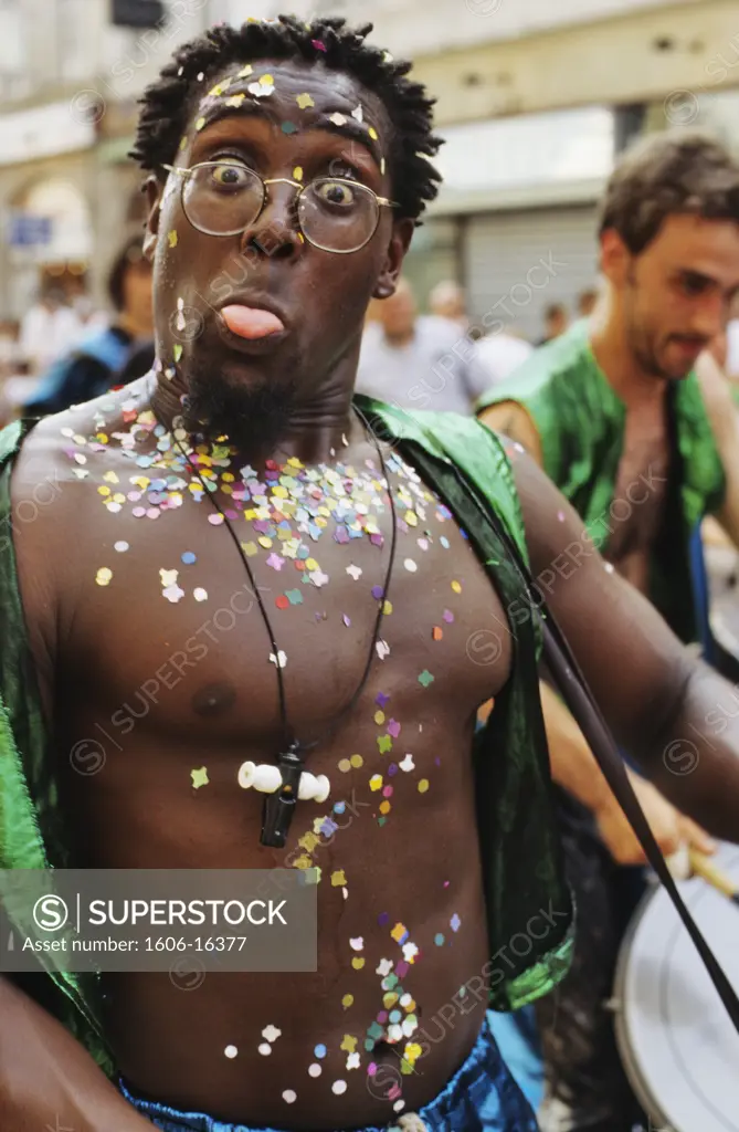 France, Nord, Douai, carnival, man in parade, looking at the camera, confettis