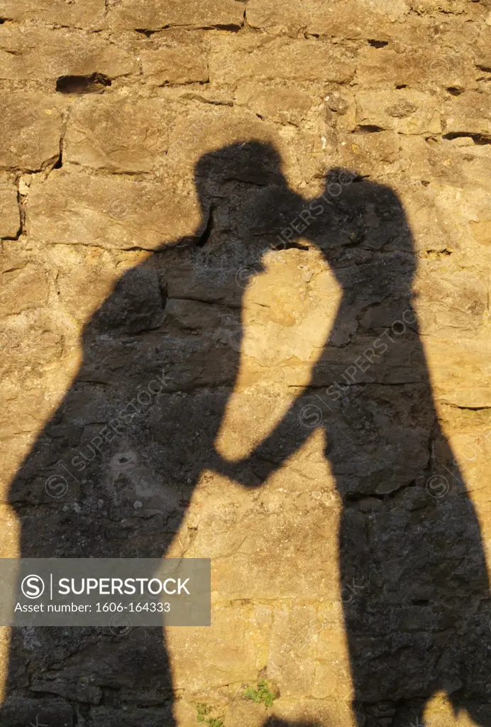 Kissing couple's shadows. France.