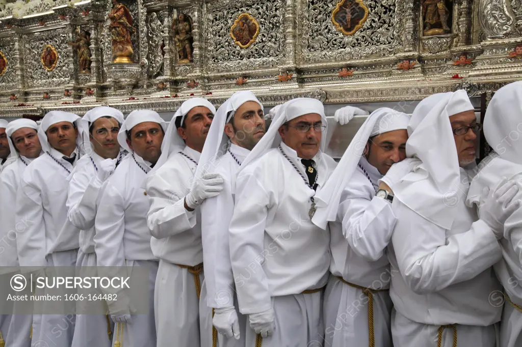 Nazarenos carrying the Rocio float at Easter week procession . Malaga. Spain.
