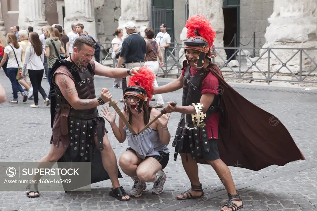 Italy,Rome,Female Tourist Posing with Men in Gladiator Costumes