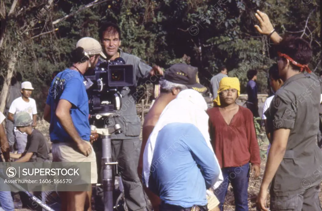 On the set, Oliver Stone directs Charlie Sheen (right) ,  , Platoon , 1986 directed by Oliver Stone Twentieth Century Fox Pictures