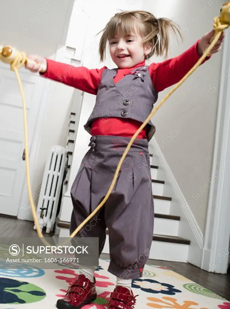 Little girl playing with a skipping rope